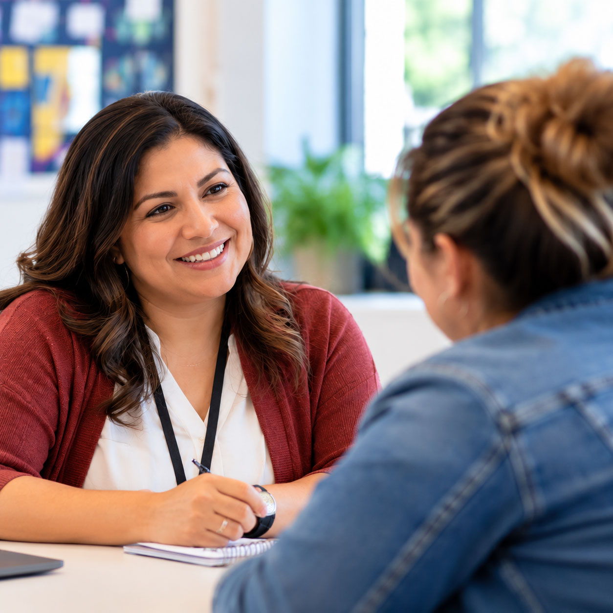 Staff member talking with a parent and offering support and guidance.
